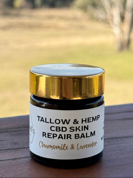 Tallow & Hemp CBD Skin Repair Balm jar with a scenic background. 